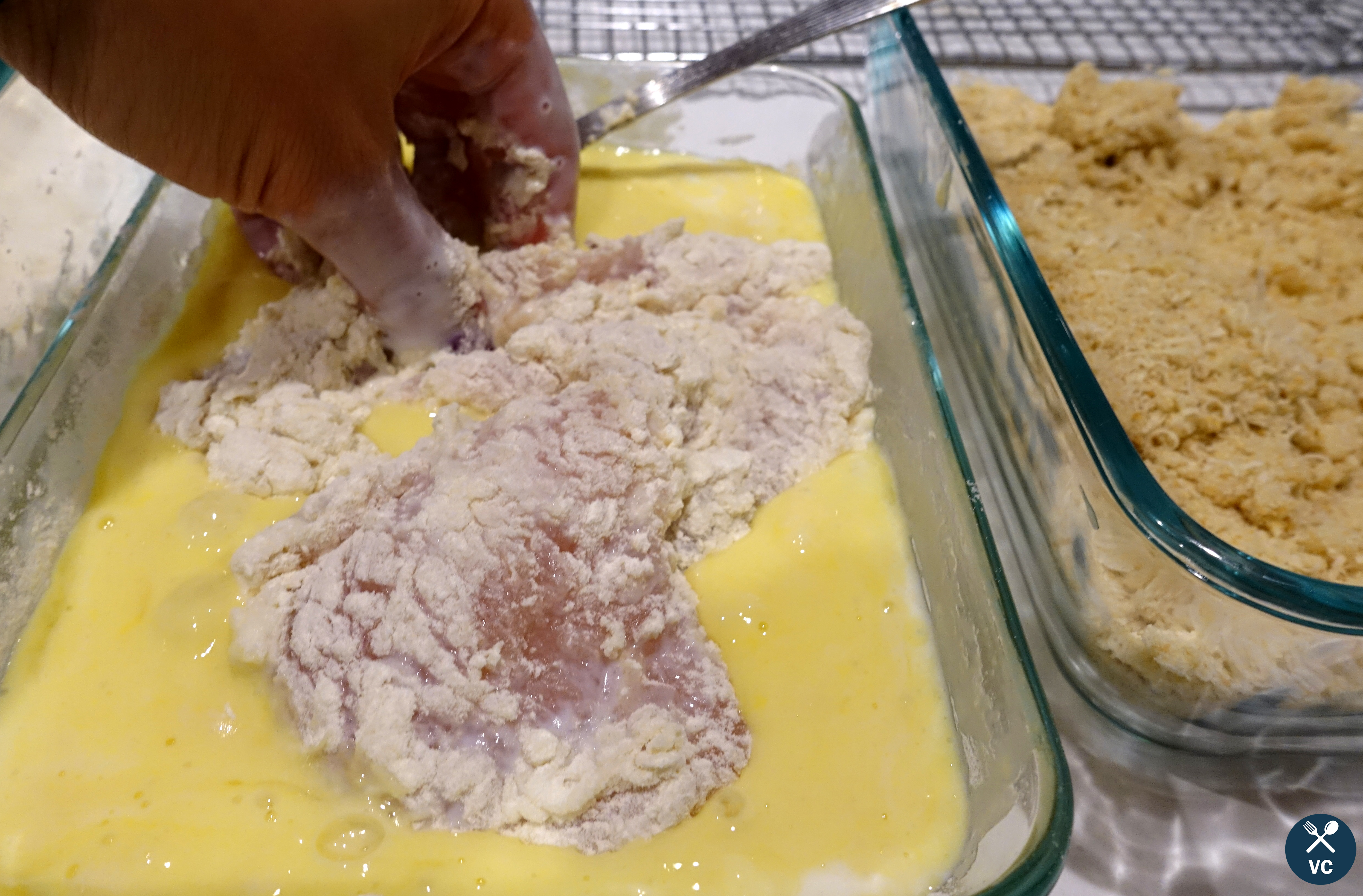 Dipping chicken breasts in egg mixture for chicken parmesan (VC in the Kitchen)
