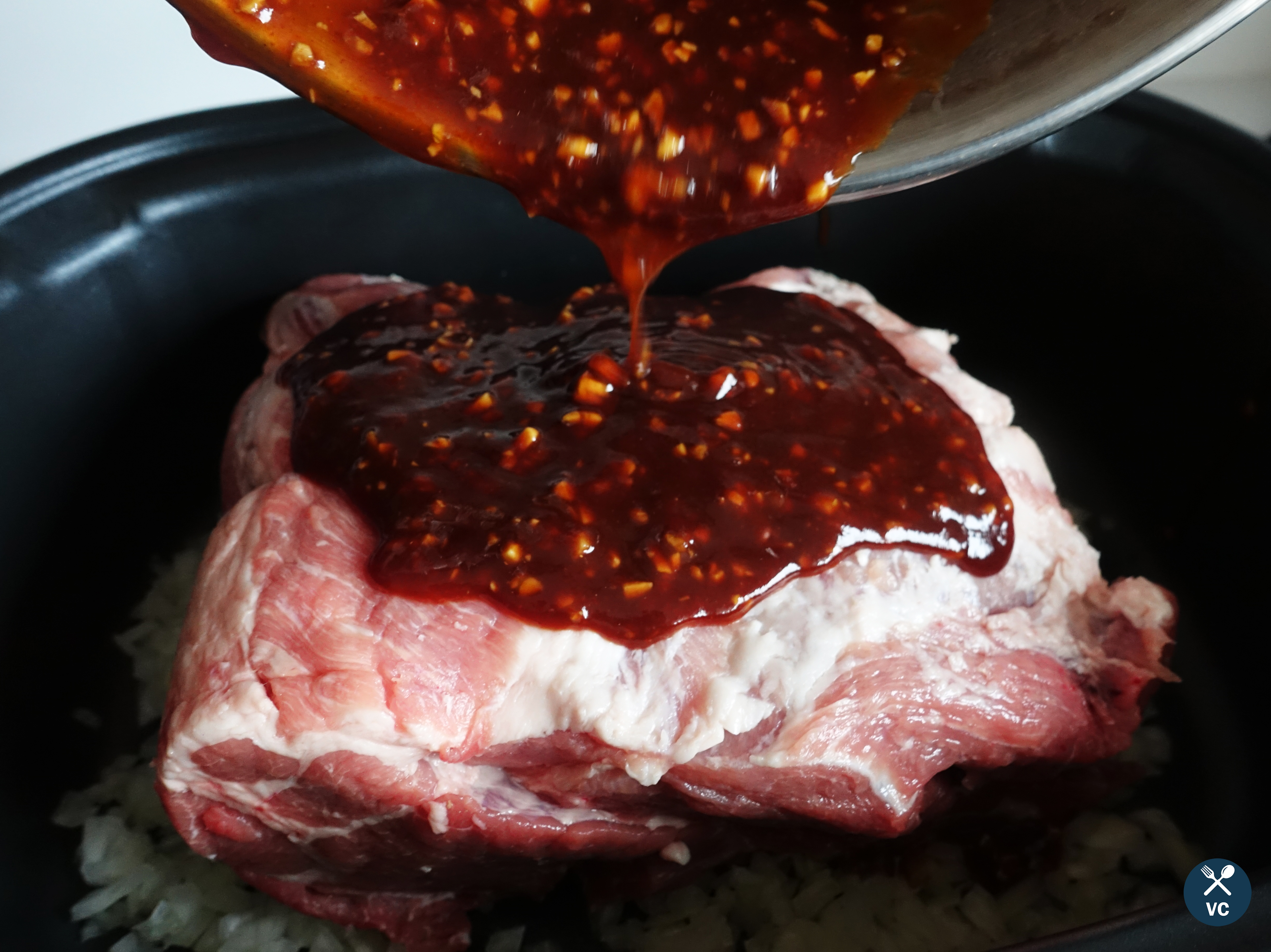Pouring on the sauce for Slow Cooker Asian Pulled Pork (VC in the Kitchen)